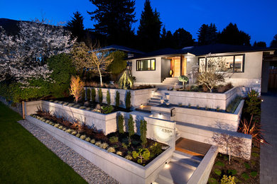 This is an example of a mid-sized midcentury two-storey concrete grey house exterior in Vancouver.