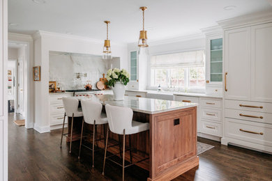 Eat-in kitchen - large traditional medium tone wood floor and brown floor eat-in kitchen idea in Detroit with a farmhouse sink, beaded inset cabinets, white cabinets, quartz countertops, white backsplash, marble backsplash, paneled appliances, an island and white countertops