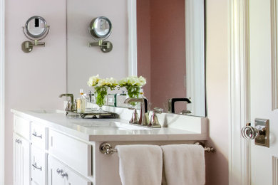 Bathroom - mid-sized eclectic master white tile and ceramic tile double-sink bathroom idea in Charlotte with shaker cabinets, white cabinets, pink walls, an undermount sink, quartz countertops, a hinged shower door, white countertops and a freestanding vanity