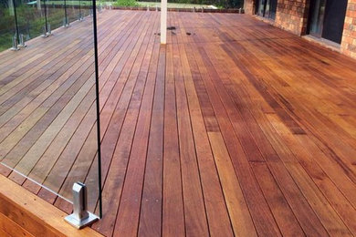 Design ideas for a large traditional backyard deck in Canberra - Queanbeyan with a pergola.