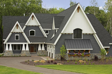 Design ideas for a mid-sized arts and crafts two-storey grey exterior in Minneapolis with mixed siding and a gable roof.
