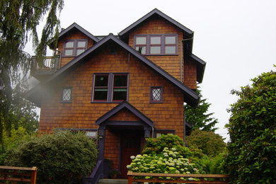 Inspiration for a large arts and crafts two-storey exterior in Seattle with wood siding.