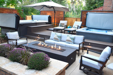Large elegant side yard patio photo in Denver with a fire pit and decking