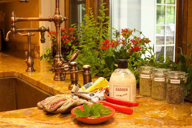 Eat-in kitchen - large mediterranean single-wall terra-cotta tile and brown floor eat-in kitchen idea in San Francisco with a farmhouse sink, yellow backsplash, stainless steel appliances, an island, shaker cabinets, white cabinets, stone tile backsplash and stainless steel countertops