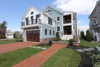 Large beach style multicolored two-story mixed siding house exterior photo in Philadelphia with a hip roof and a shingle roof