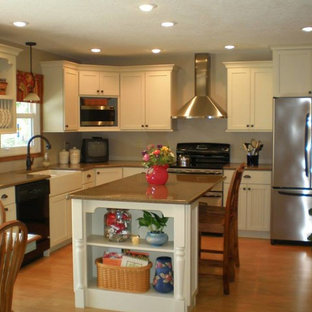 Kitchen pantry ideas - Inspiration for a galley medium tone wood floor kitchen pantry remodel in Cedar Rapids with a drop-in sink, recessed-panel cabinets, white cabinets, granite countertops, gray backsplash, black appliances and no island