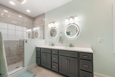 Example of a large transitional master beige tile and porcelain tile porcelain tile and double-sink doorless shower design in Cleveland with shaker cabinets, gray cabinets, green walls, an undermount sink, quartz countertops, a hinged shower door, white countertops and a built-in vanity
