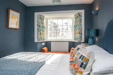 Design ideas for a bohemian master bedroom in Dorset with blue walls.