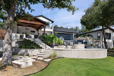 Modern white two-story stucco house exterior idea in Austin with a black roof