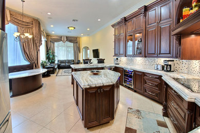 Kitchen pantry - mid-sized contemporary single-wall ceramic tile kitchen pantry idea in Miami with a drop-in sink, beaded inset cabinets, brown cabinets, granite countertops, beige backsplash, ceramic backsplash, stainless steel appliances and an island
