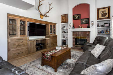 Example of a family room design in Denver with a wall-mounted tv