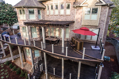 Example of a large arts and crafts backyard outdoor kitchen deck design in Atlanta with a pergola