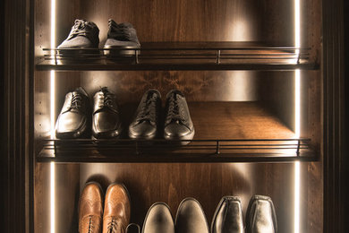 Walk-in closet - mid-sized modern men's carpeted walk-in closet idea in Tampa with open cabinets and dark wood cabinets