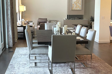 Example of a huge trendy brown floor, coffered ceiling and dark wood floor dining room design in Detroit with beige walls and a ribbon fireplace