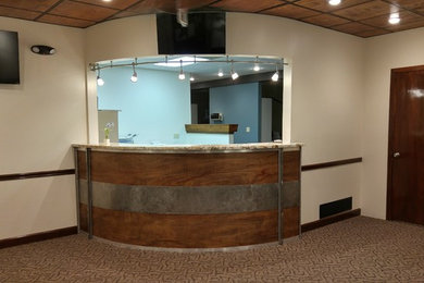 Example of a mid-sized minimalist u-shaped carpeted home bar design in Kansas City with granite countertops