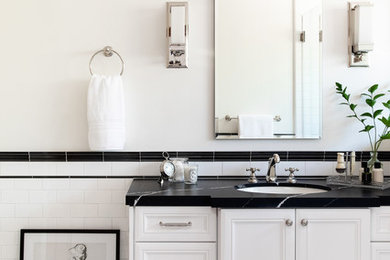 Double shower - mid-sized mediterranean master black and white tile and ceramic tile marble floor and white floor double shower idea in San Diego with furniture-like cabinets, white cabinets, a one-piece toilet, white walls, an undermount sink, quartz countertops, a hinged shower door and black countertops