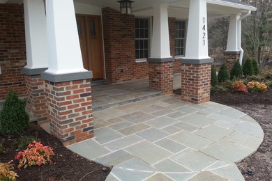 Mid-sized traditional front yard verandah in DC Metro with tile and a roof extension.