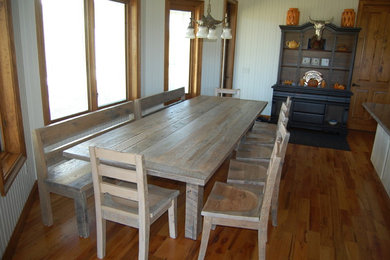 Example of a large mountain style medium tone wood floor kitchen/dining room combo design in Orlando with white walls and no fireplace