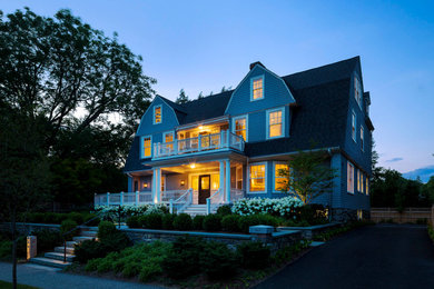 This is an example of a large traditional three-storey grey exterior in Boston with wood siding, a gambrel roof and a shingle roof.