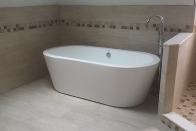 Example of a large trendy master beige tile and ceramic tile ceramic tile bathroom design in Tampa with a one-piece toilet