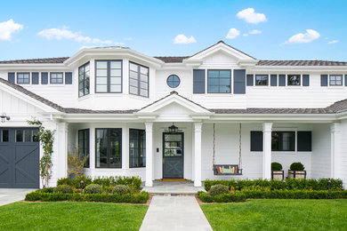 Design ideas for a beach style two-storey white exterior in Orange County.
