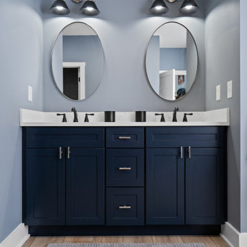 Warm and Cohesive Multi-Bathroom Design In Nokesville