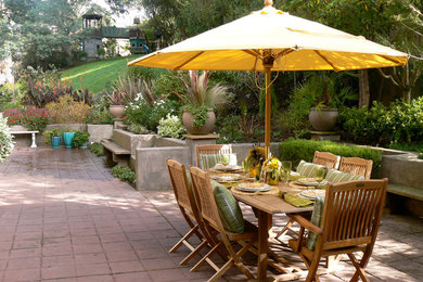 Huge tuscan backyard patio kitchen photo in San Francisco with no cover