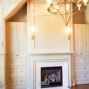 Built-in library bookcase with chevron style panel and custom mantel