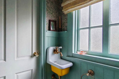 This is an example of a large classic cloakroom in Other with freestanding cabinets, yellow cabinets, a one-piece toilet, marble flooring, a wall-mounted sink and a floating vanity unit.