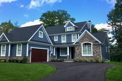 Arts and crafts blue two-story mixed siding exterior home photo in Philadelphia with a mixed material roof