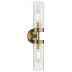 Livex Lighting - Ludlow 2 Light Antique Brass ADA Vanity Sconce - Add a dash of character and radiance to your home with this wall sconce. This two-light fixture from the Ludlow Collection features an antique brass finish with a clear glass. The clean lines of the back plate complement the cylindrical glass shades creating a minimal, sleek, urban look that works well in most decors. This fixture adds upscale charm and contemporary aesthetics to your home.