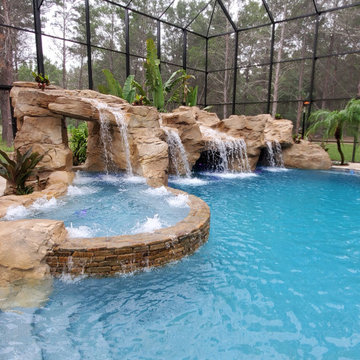 Resort Inspired Pool with Grotto and Sunken Firepit Lounge