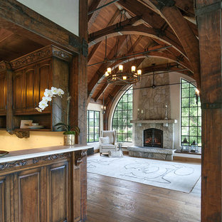 Example of a mid-sized farmhouse open concept medium tone wood floor family room design in Santa Barbara with a standard fireplace and a stone fireplace