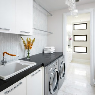 Inspiration for a transitional laundry room remodel in Toronto with white cabinets and black countertops