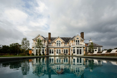 Large transitional backyard stone and rectangular natural pool photo in Boston