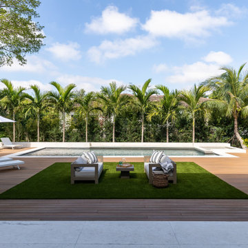 Luxury Home With Pool and Chairs - Surrounded by Trees and a Blue Sky