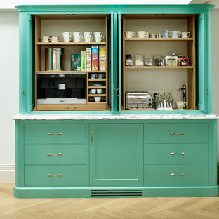 Farmhouse kitchen pantry ideas - Country light wood floor kitchen pantry photo in Kent with flat-panel cabinets and green cabinets