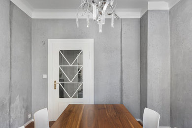 This is an example of a contemporary separate dining room in Stuttgart with grey walls and dark hardwood floors.