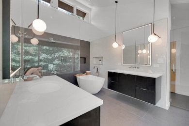 Inspiration for a mid-sized modern master white tile and ceramic tile mosaic tile floor, gray floor and double-sink bathroom remodel in DC Metro with flat-panel cabinets, black cabinets, a one-piece toilet, a drop-in sink, white countertops, a niche and a floating vanity