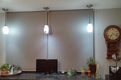 Example of a mid-sized trendy single-wall medium tone wood floor eat-in kitchen design in Other with a single-bowl sink, granite countertops, metallic backsplash and stainless steel appliances