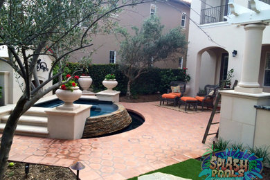 Inspiration for a mid-sized backyard tile and custom-shaped hot tub remodel in Orange County