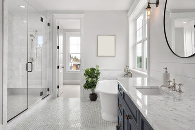 Inspiration for a mid-sized modern master porcelain tile, double-sink, tray ceiling, wall paneling and wainscoting bathroom remodel in New York with a two-piece toilet, an undermount sink, quartz countertops, a hinged shower door, a niche, a built-in vanity and recessed-panel cabinets