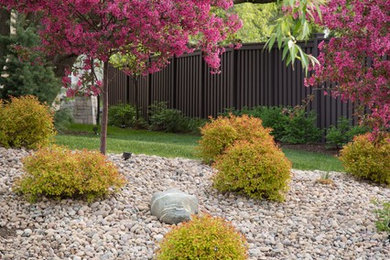 Design ideas for a large traditional side yard full sun xeriscape for spring in Salt Lake City with gravel.