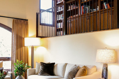 Large country dark wood floor living room library photo in San Diego