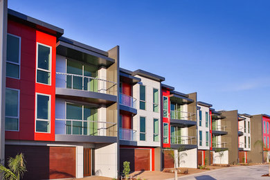 Photo of a modern three-storey red exterior in Melbourne.