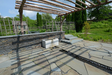 Photo of a huge rustic full sun backyard stone landscaping in New York for summer.