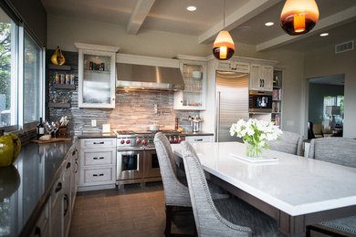 Inspiration for a large transitional porcelain tile open concept kitchen remodel in Los Angeles with an undermount sink, recessed-panel cabinets, gray cabinets, quartz countertops, gray backsplash, glass tile backsplash, stainless steel appliances and an island