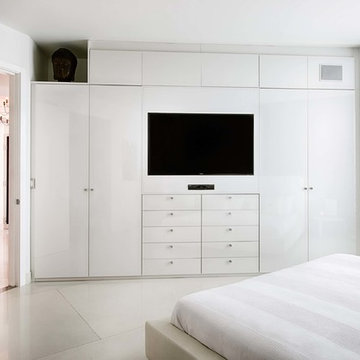 Modern white bedroom with custom cabinetwall and wooden headboard