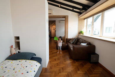 Example of a small trendy gender-neutral medium tone wood floor and brown floor kids' room design in Singapore with white walls