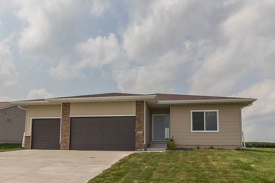 Mid-sized transitional brown one-story vinyl exterior home idea in Other
